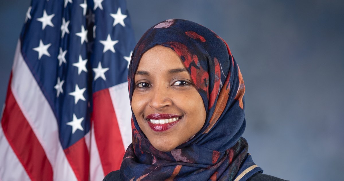 Official portrait of Rep. Ilhan Omar in front of an American flag